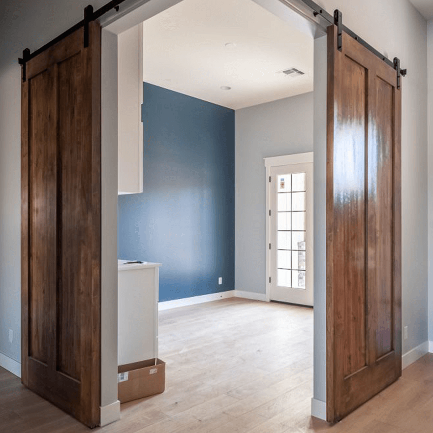 Corner barn door in custom luxury home. Custom home designed and built by Resurrection Builders in Gilbert.